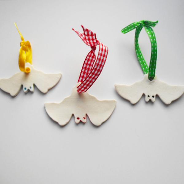 Porcelain Christmas Bat Tree Decorations by Lesley McShea, with green, red and yellow ribbons